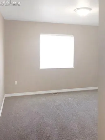 a view of an empty room and a window