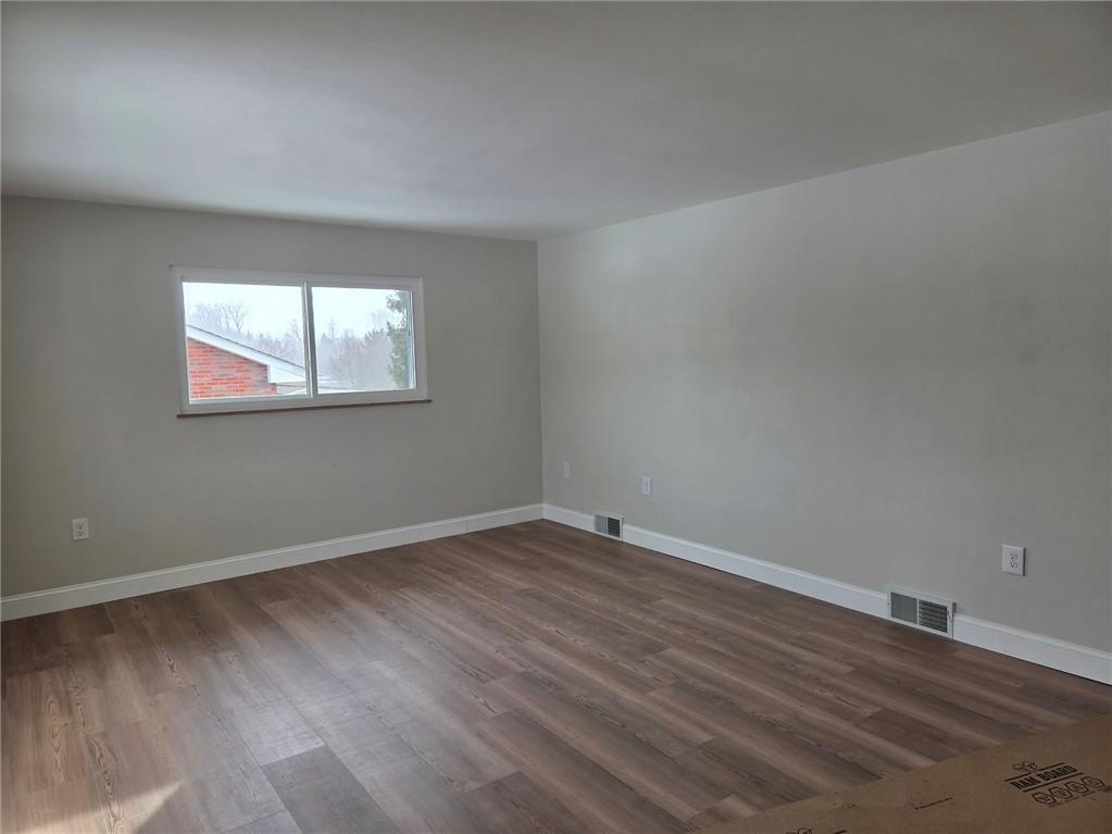 265 North Duffy Road Butler, PA 16001 - Photo 16 of 41 an empty room with wooden floor and windows