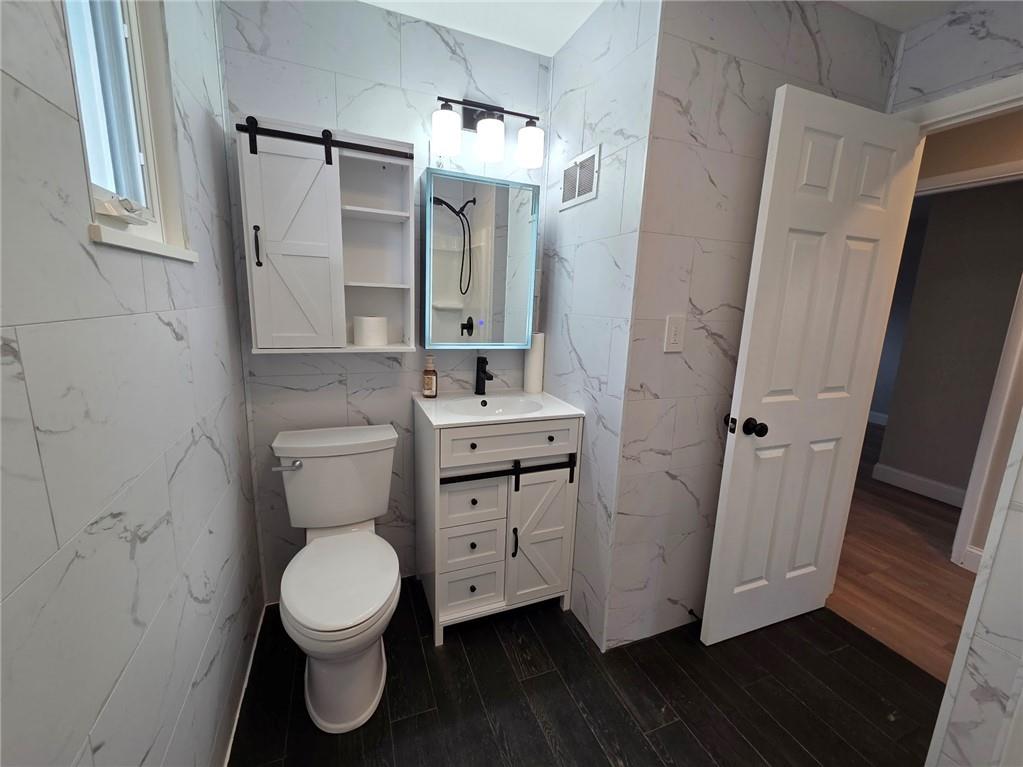 265 North Duffy Road Butler, PA 16001 - Photo 22 of 41 a bathroom with a toilet sink and a mirror