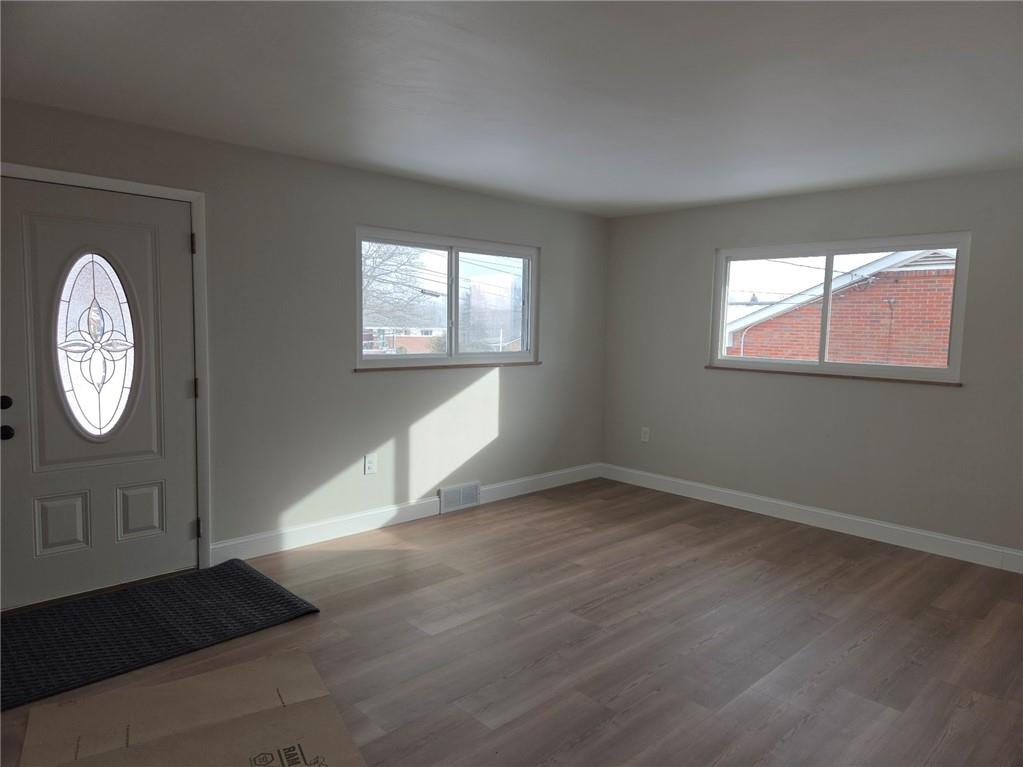 265 North Duffy Road Butler, PA 16001 - Photo 4 of 41 an empty room with wooden floor and windows