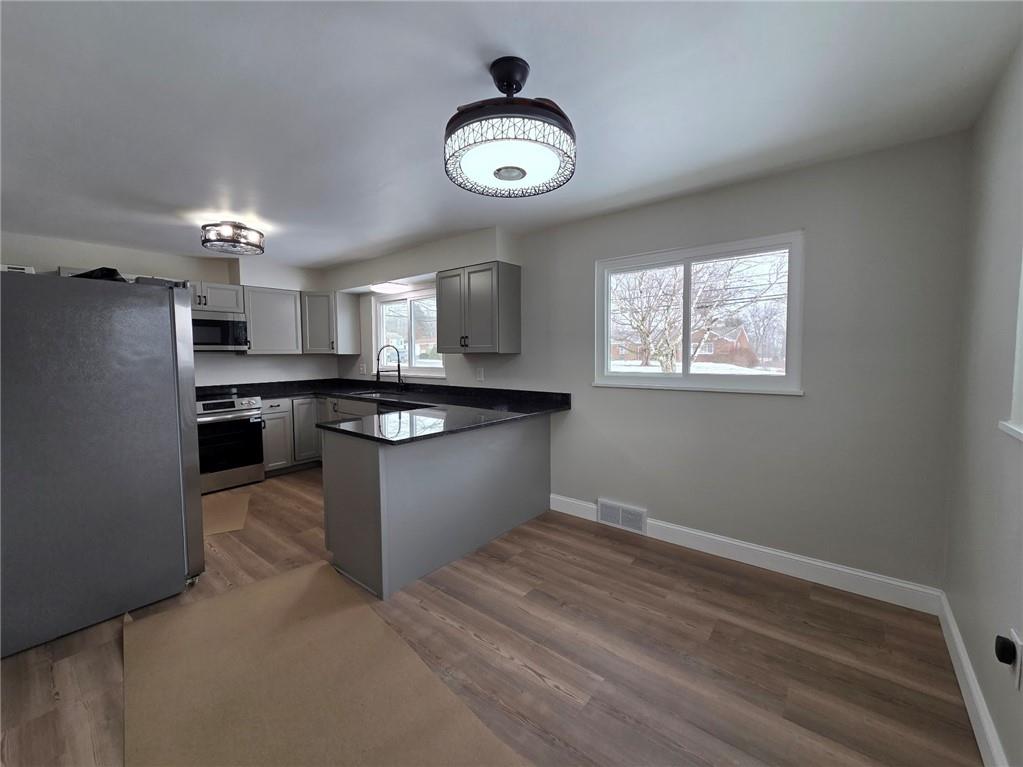 265 North Duffy Road Butler, PA 16001 - Photo 7 of 41 a kitchen with granite countertop a stove and cabinets