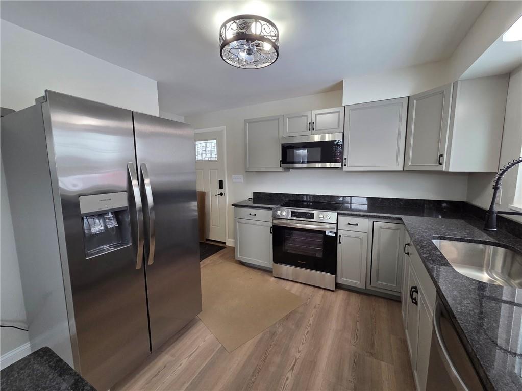 265 North Duffy Road Butler, PA 16001 - Photo 9 of 41 a kitchen with stainless steel appliances granite countertop a refrigerator a stove a sink and a microwave