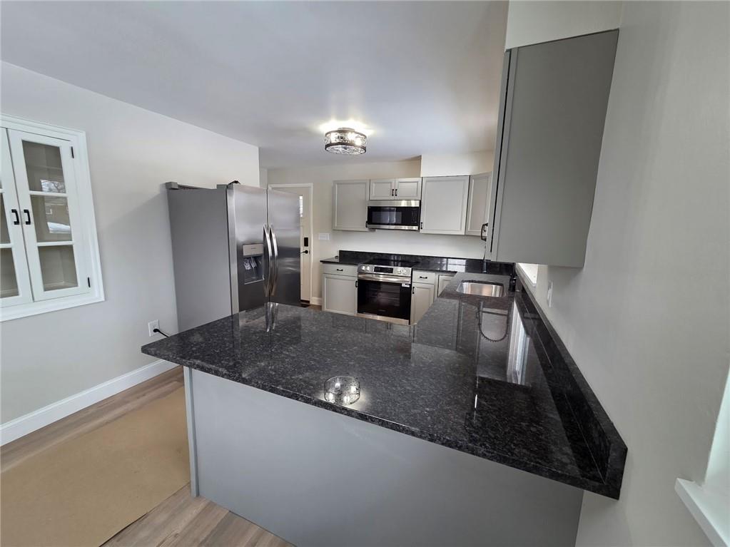 265 North Duffy Road Butler, PA 16001 - Photo 10 of 41 a kitchen with stainless steel appliances granite countertop a sink stove and refrigerator