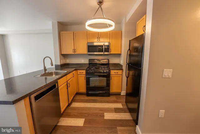 a kitchen with a refrigerator and a sink