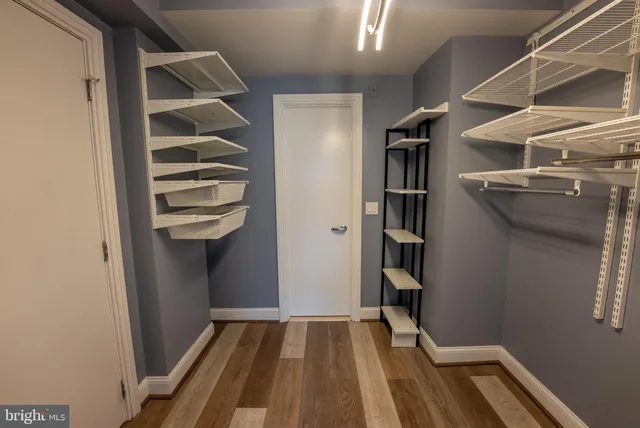 a view of walk in closet with empty racks