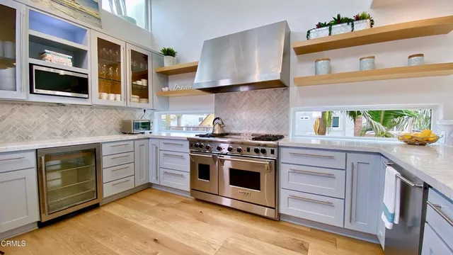a kitchen with stainless steel appliances granite countertop a stove and a sink