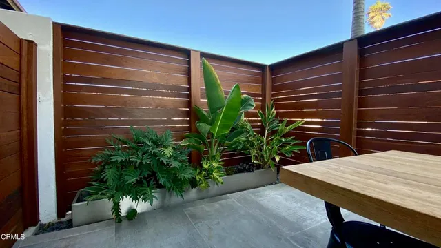 a bed sitting in a bedroom next to a bathroom