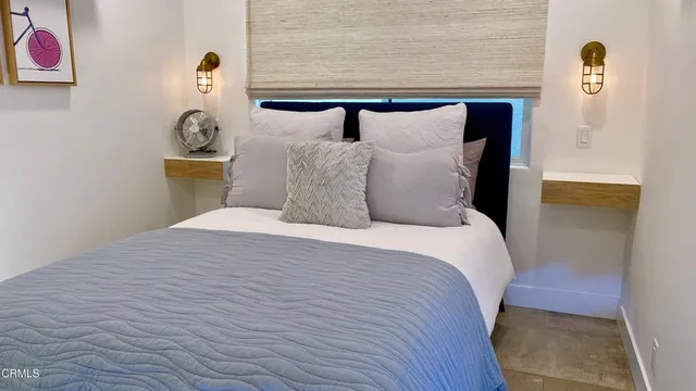 a bathroom with a granite countertop sink a toilet a mirror and shower