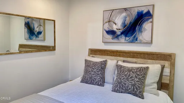 a living room with furniture fireplace and a large window