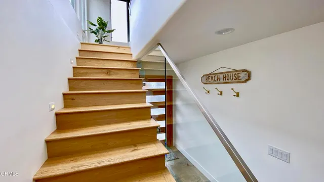 a living room with furniture a flat screen tv and a large window