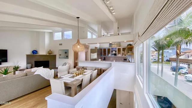a living room with furniture a fireplace and a dining table