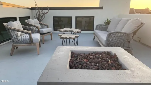a view of a hallway with furniture and stairs