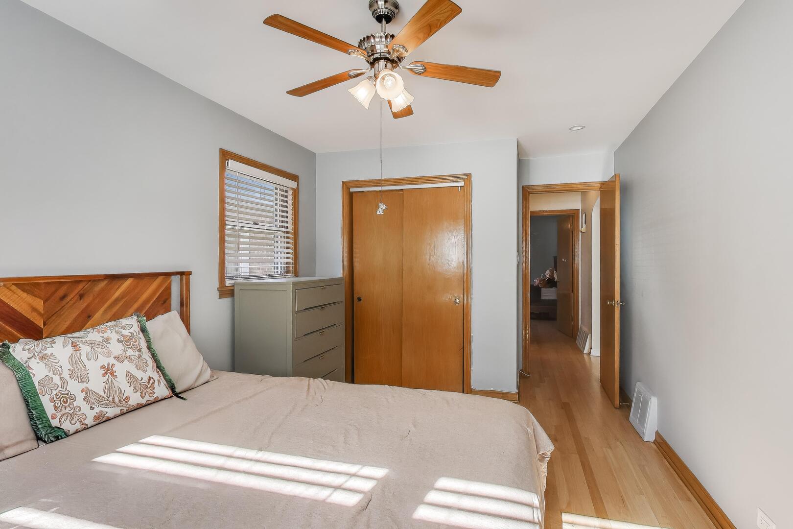 Undisclosed Address Chicago, IL 60655 - Photo 14 of 25 a bedroom with a bed and a chandelier