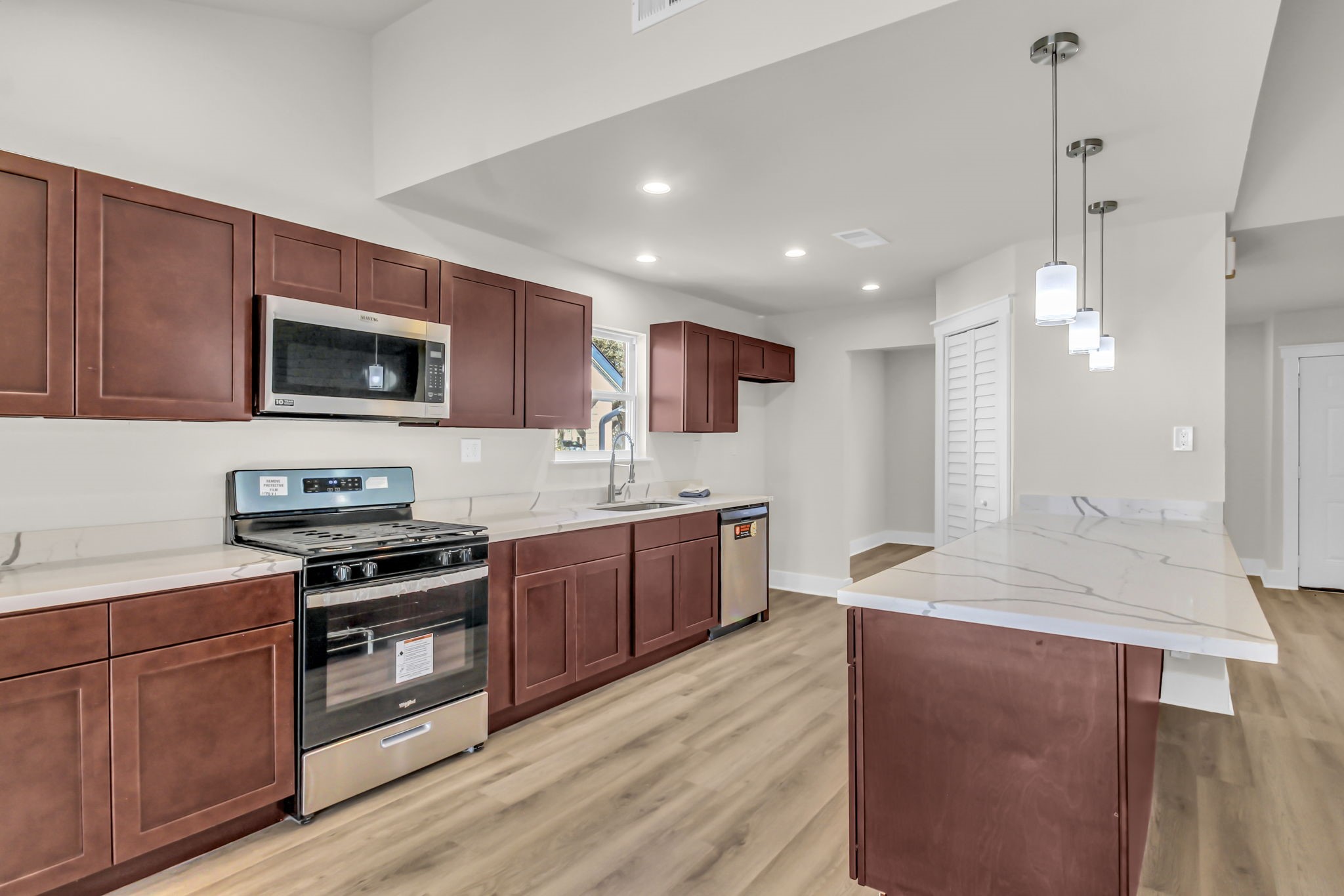 11630 Sagewillow Lane Houston, TX 77089 - Photo 11 of 25 a kitchen with stainless steel appliances granite countertop wooden cabinets a stove top oven a sink and dishwasher with wooden floor