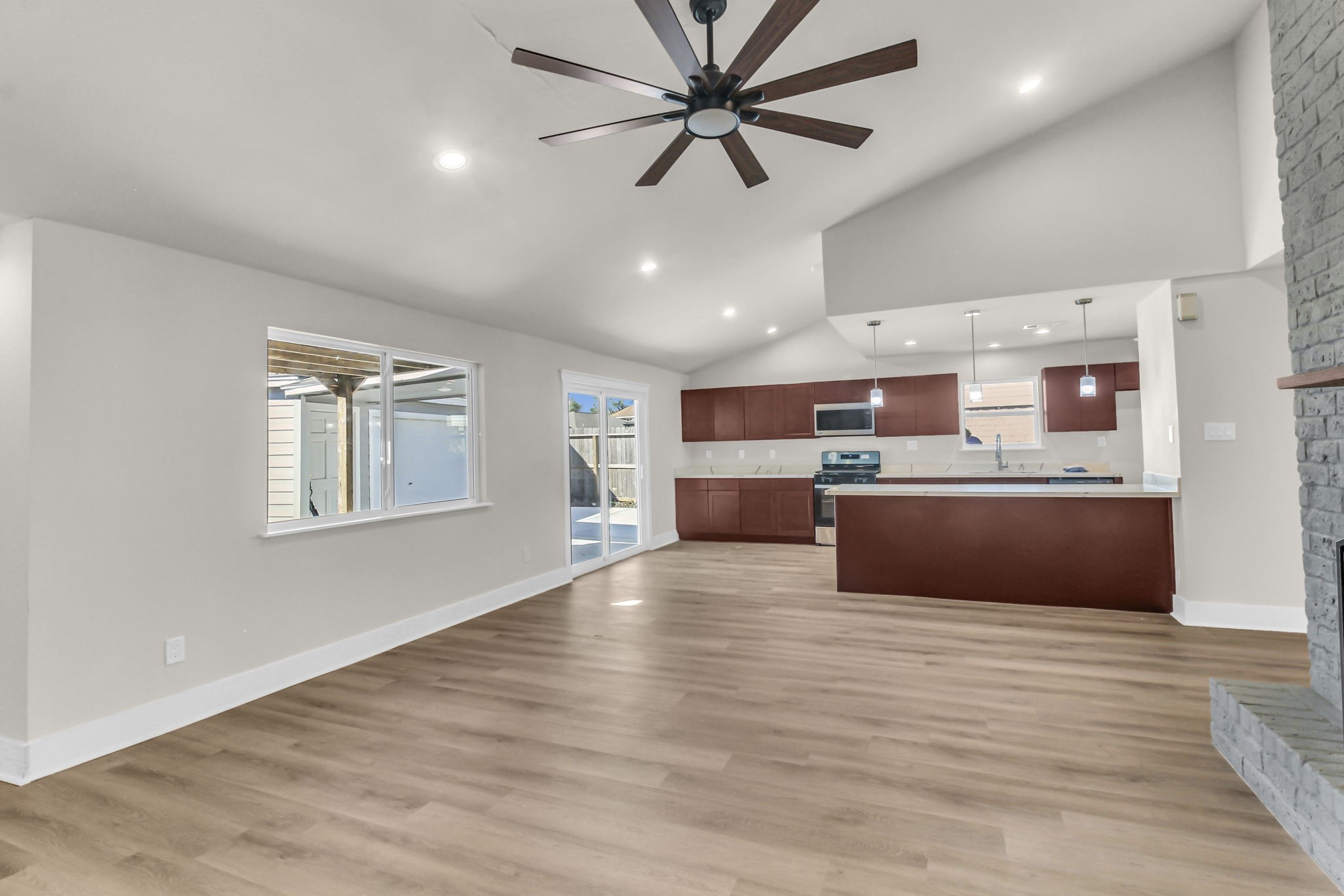 11630 Sagewillow Lane Houston, TX 77089 - Photo 12 of 25 a large kitchen with stainless steel appliances kitchen island a large counter top and a chandelier