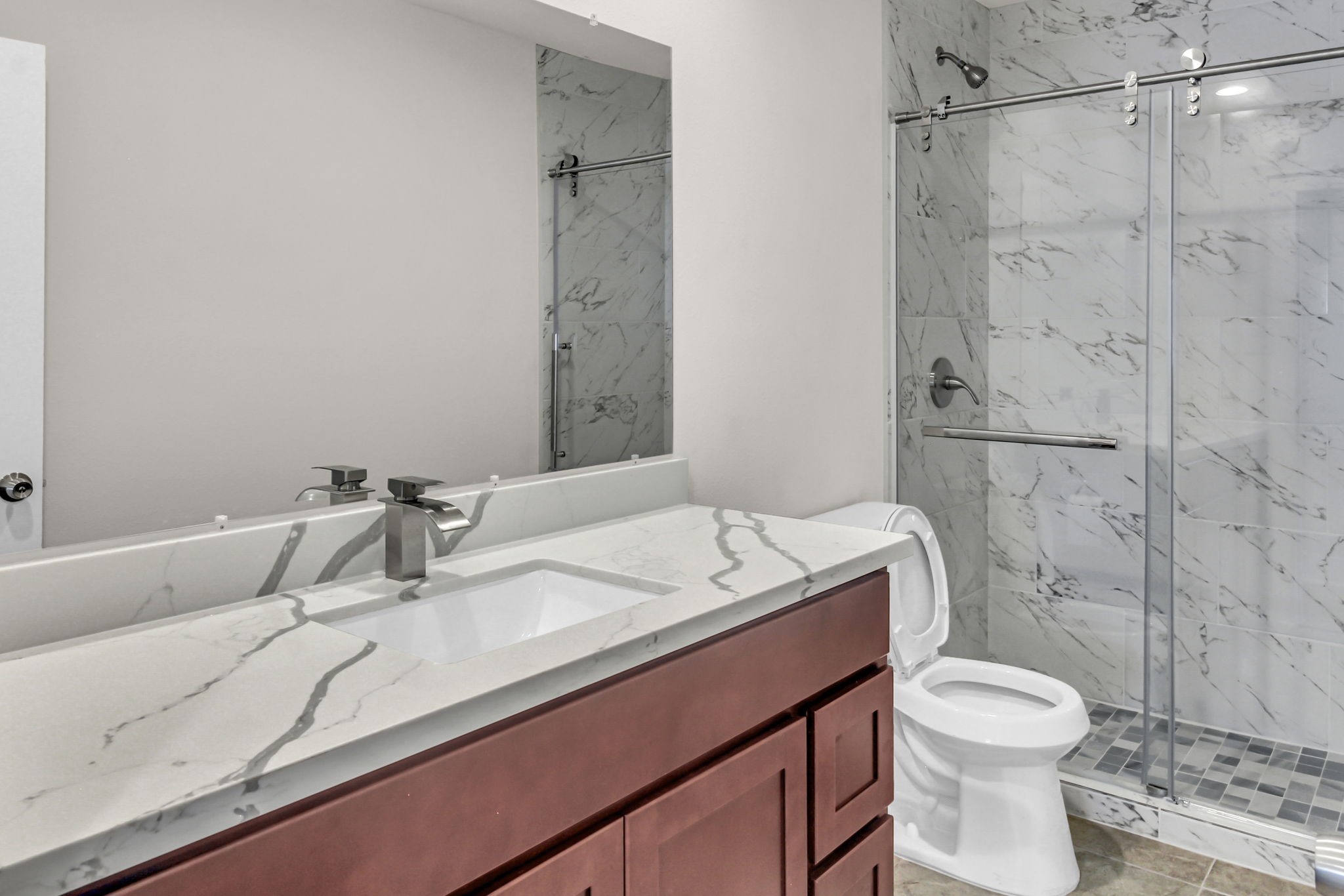 11630 Sagewillow Lane Houston, TX 77089 - Photo 17 of 25 a bathroom with a sink toilet vanity and shower