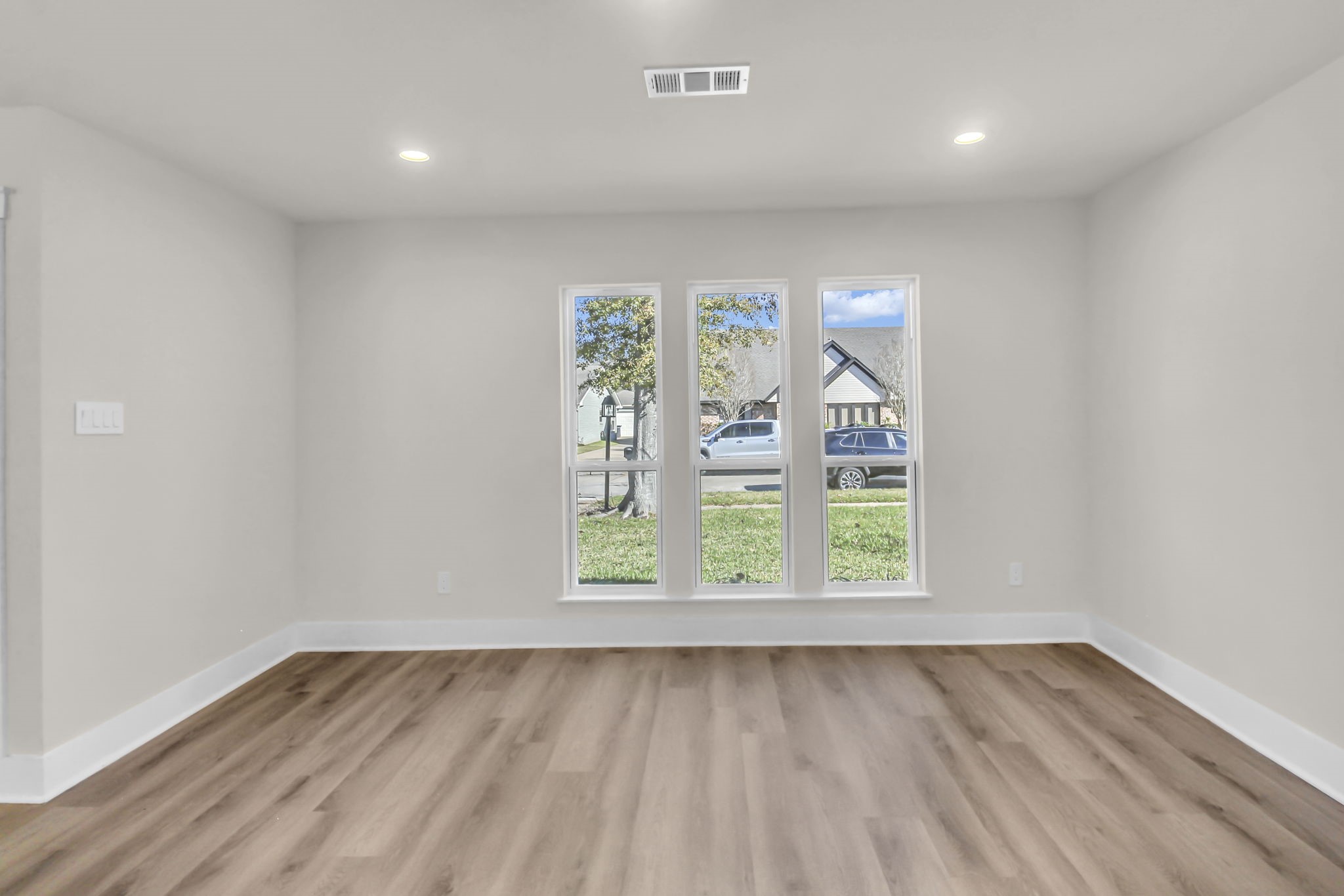 11630 Sagewillow Lane Houston, TX 77089 - Photo 6 of 25 an empty room with wooden floor and windows