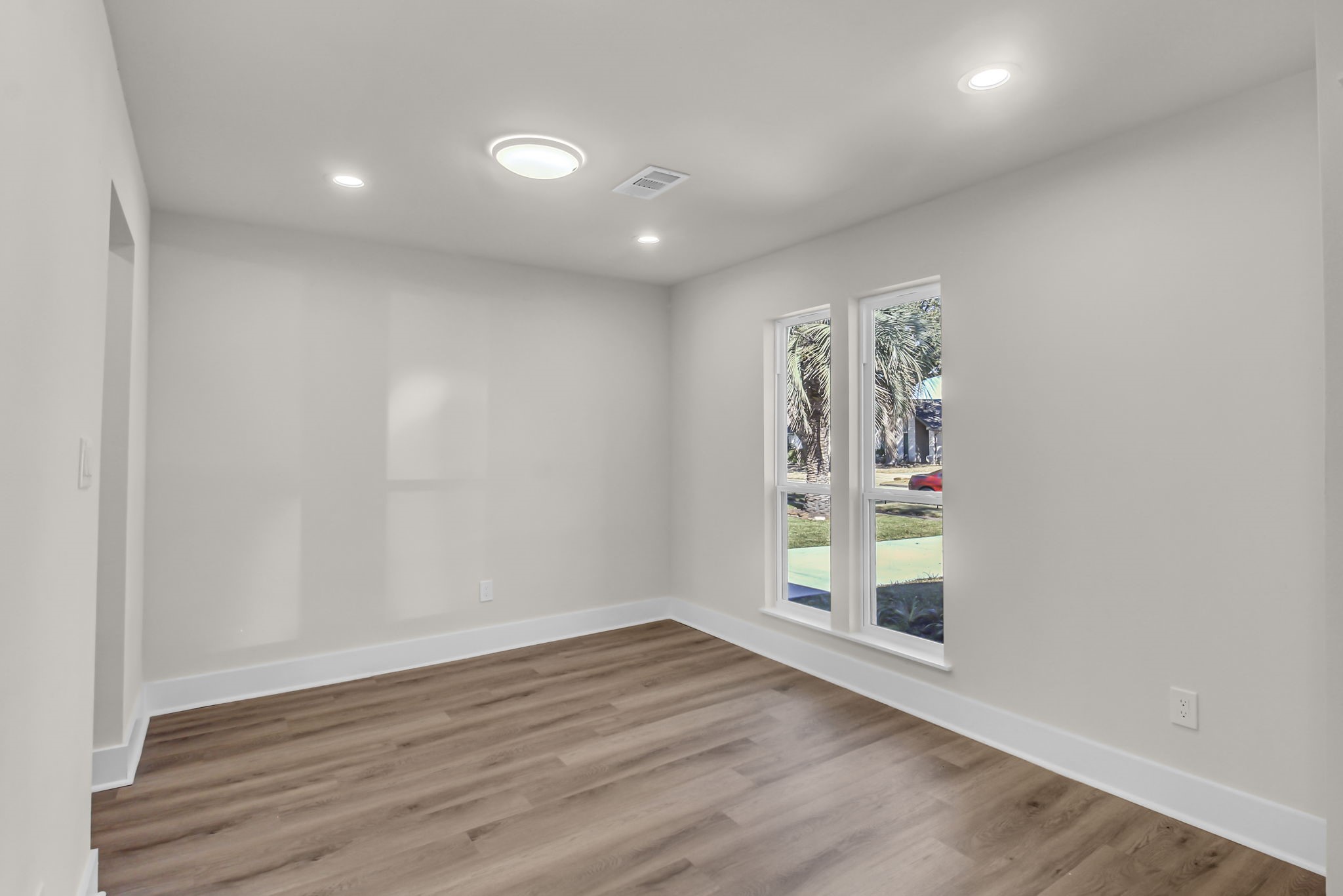 11630 Sagewillow Lane Houston, TX 77089 - Photo 7 of 25 a view of an empty room with wooden floor and a window