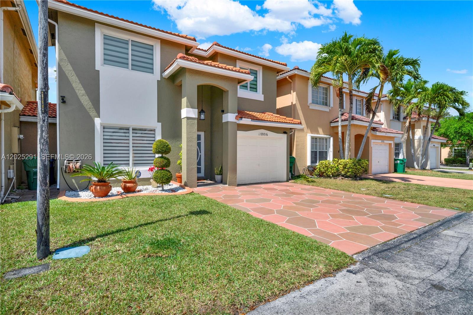 10006 Southwest 162nd Path Miami, FL 33196 - Photo 2 of 40 a front view of house with yard and green space