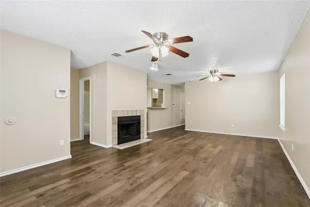 wooden floor in an empty room with a fireplace
