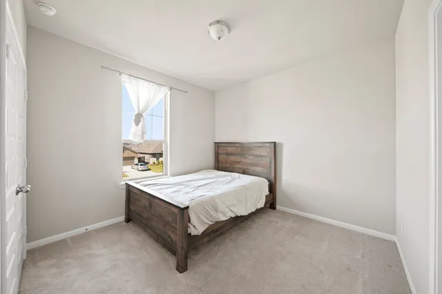 a bedroom with a bed and window