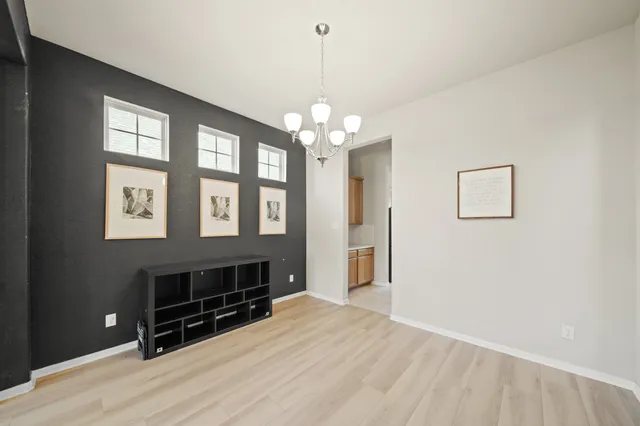 a view of a livingroom with a furniture wooden floor and chandelier
