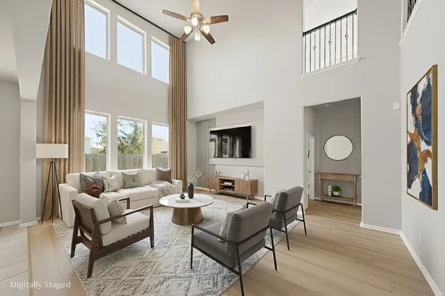 a living room with furniture a fireplace and a large window