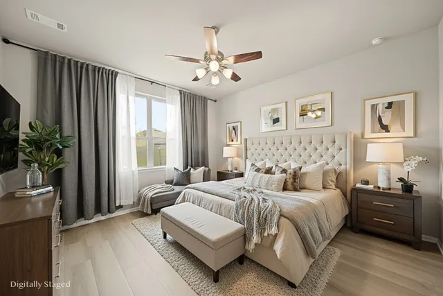 a bedroom with a large bed and a chandelier