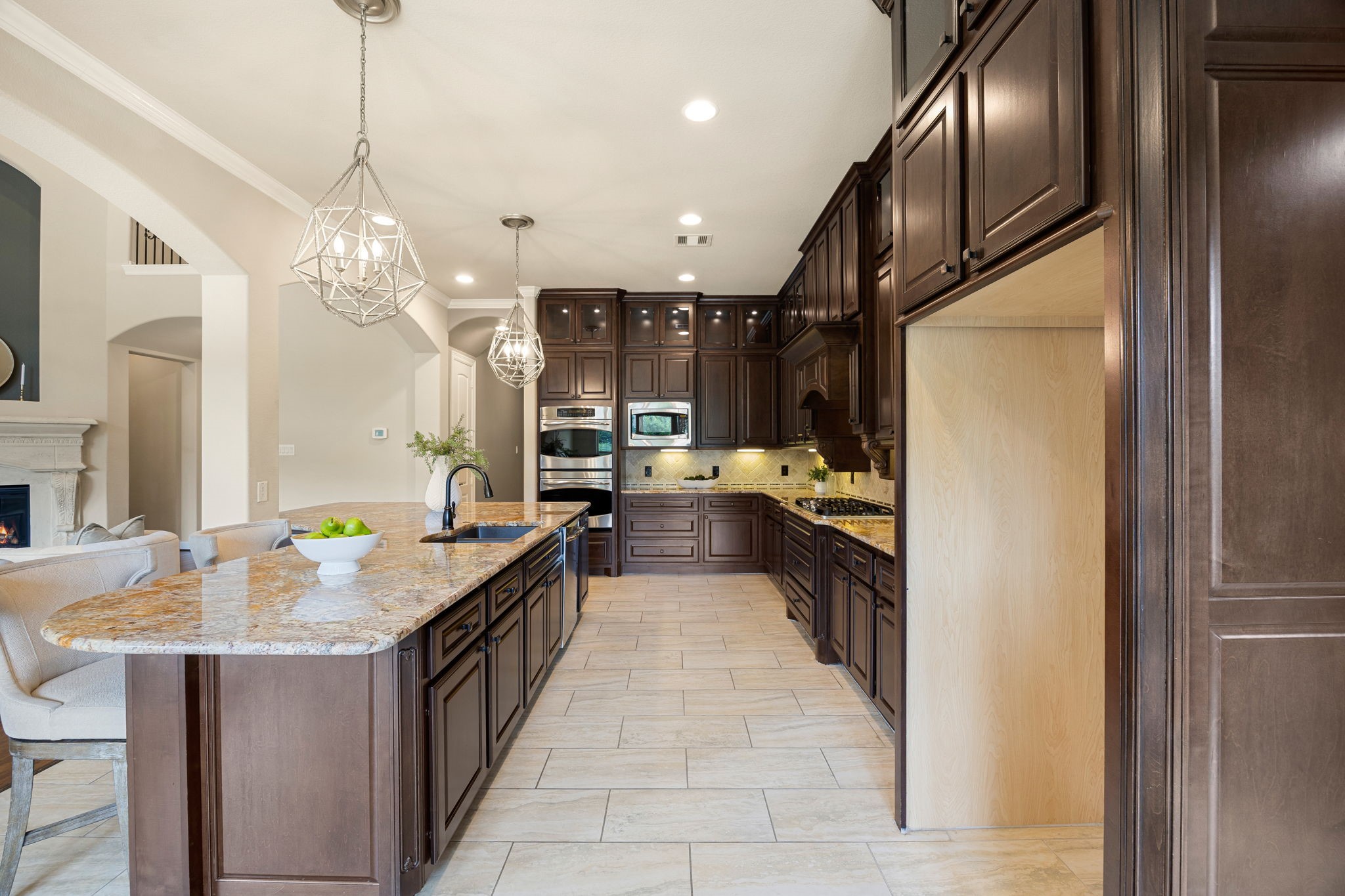 3306 Reston Landing Lane Katy, TX 77494 - Photo 18 of 50 Beautiful kitchen finishes include granite countertops, rich dark cabinetry, and sleek stainless steel appliances.