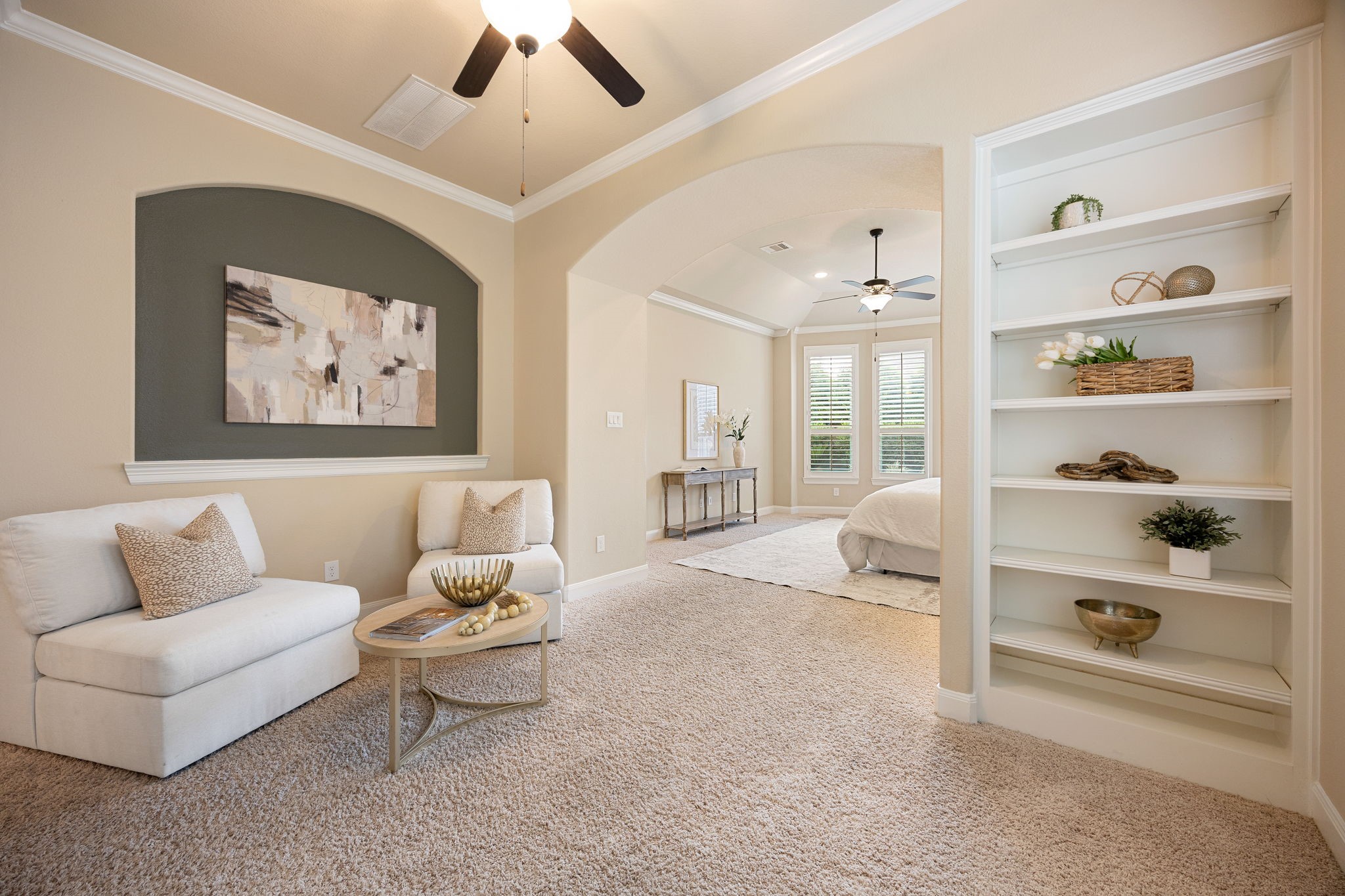 3306 Reston Landing Lane Katy, TX 77494 - Photo 25 of 50 Step into the primary suite featuring a dedicated sitting area with built-in shelving, offering a cozy and serene retreat within the home.