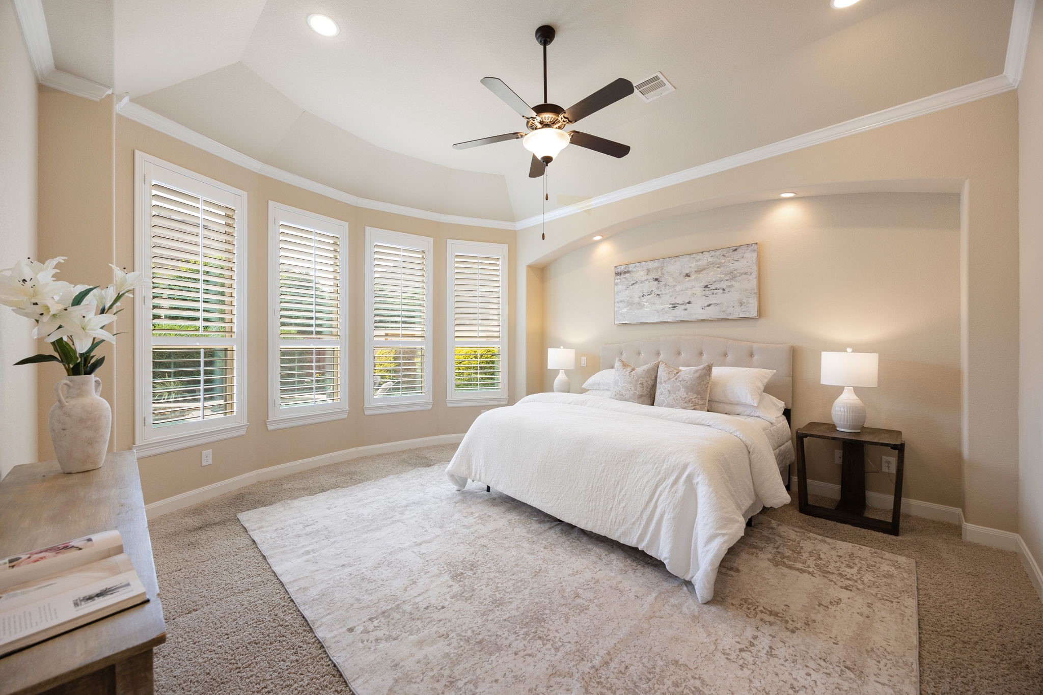 3306 Reston Landing Lane Katy, TX 77494 - Photo 27 of 50 The primary suite continues its retreat-like ambiance into the bedroom, where expansive windows framed with plantation shutters showcase stunning views of the backyard oasis.