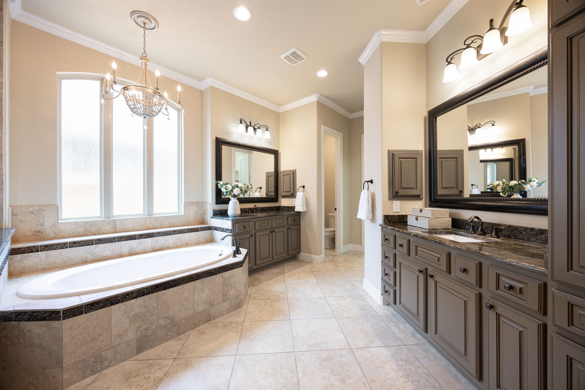 3306 Reston Landing Lane Katy, TX 77494 - Photo 28 of 50 The spa-inspired primary bath showcases dual vanities, a soaking tub, a spacious stand-alone shower, and two generously sized walk-in closets, providing exceptional comfort and convenience.