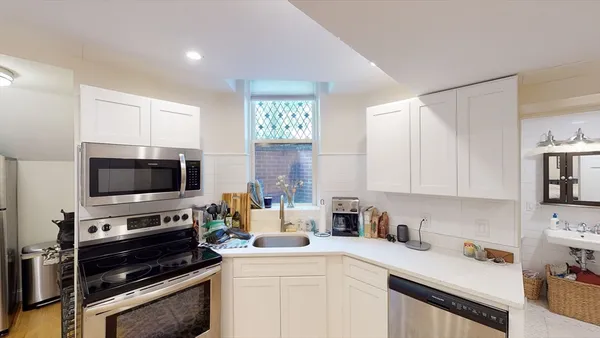 a kitchen with a stove a sink and a microwave