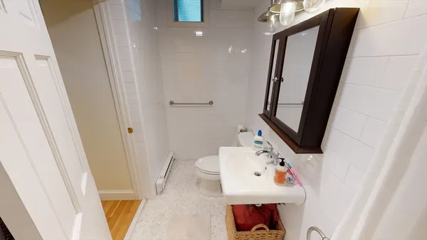a bathroom with a sink toilet and mirror