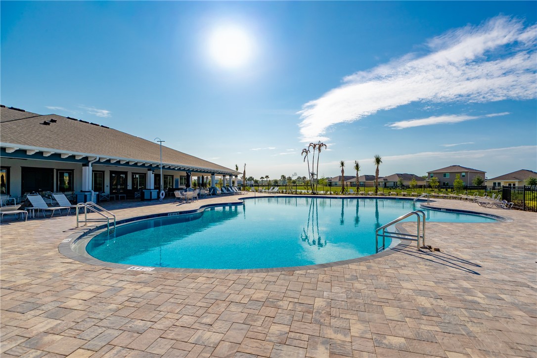 3453 Trinity Circle Fort Pierce, FL 34945 - Photo 28 of 36 a swimming pool with outdoor seating and yard