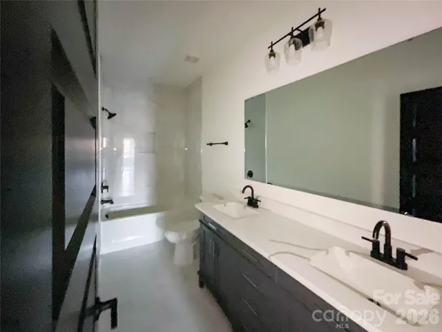 a bathroom with a double vanity sink and mirror