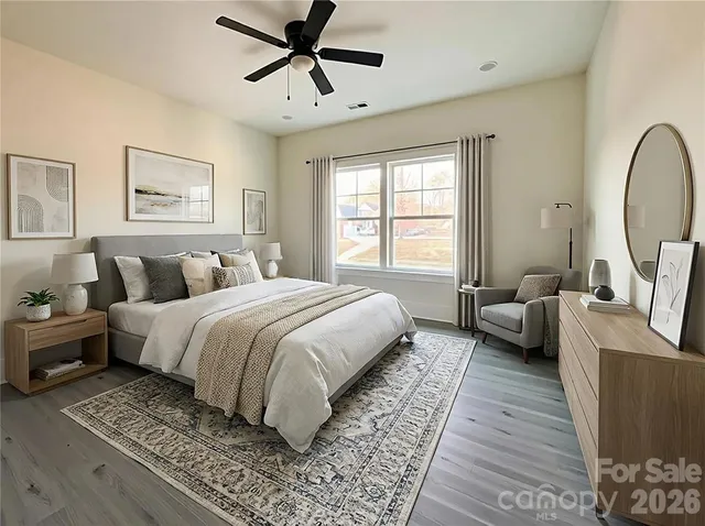 a spacious bedroom with a bed couch and a window