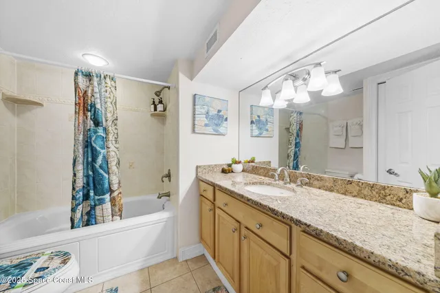 a bathroom with a granite countertop sink mirror and a bathtub