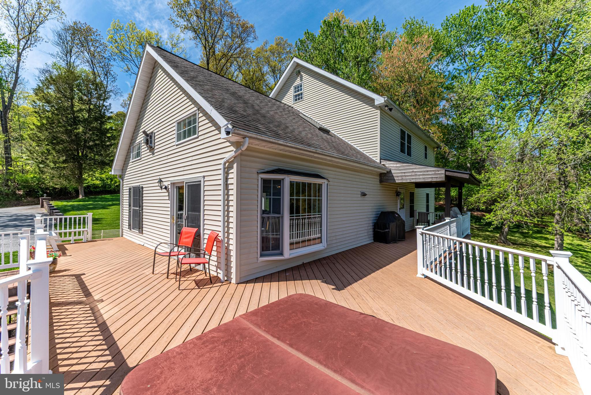 20413 Gore Mill Road Freeland, MD 21053 - Photo 18 of 35 a view of a house with a deck and a yard
