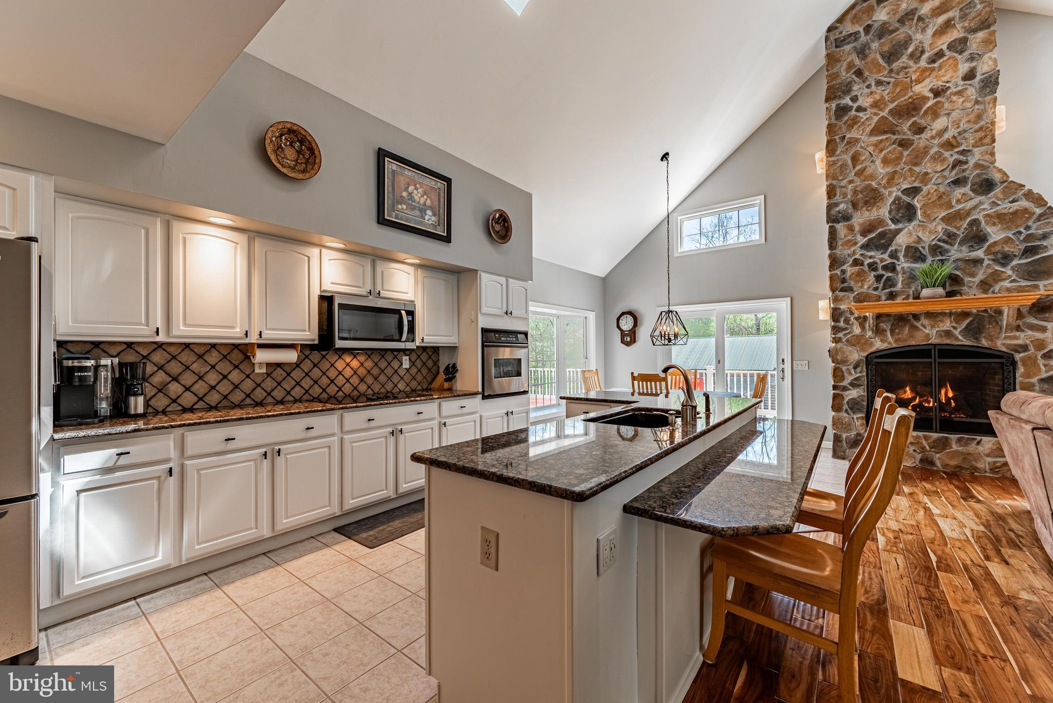 20413 Gore Mill Road Freeland, MD 21053 - Photo 6 of 35 a kitchen with stainless steel appliances granite countertop a stove and white cabinets