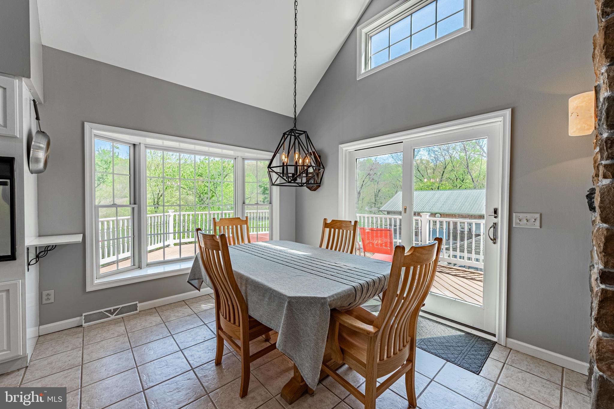 20413 Gore Mill Road Freeland, MD 21053 - Photo 7 of 35 a dining room with furniture a chandelier and wooden floor