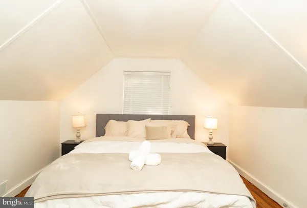 a view of a room with wooden floor and furniture