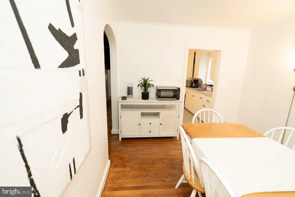 a view of a dining room with furniture and a potted plant