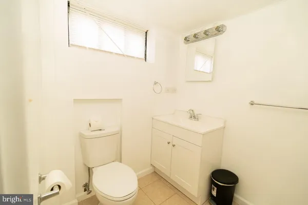 a white toilet sitting next to a bathroom sink