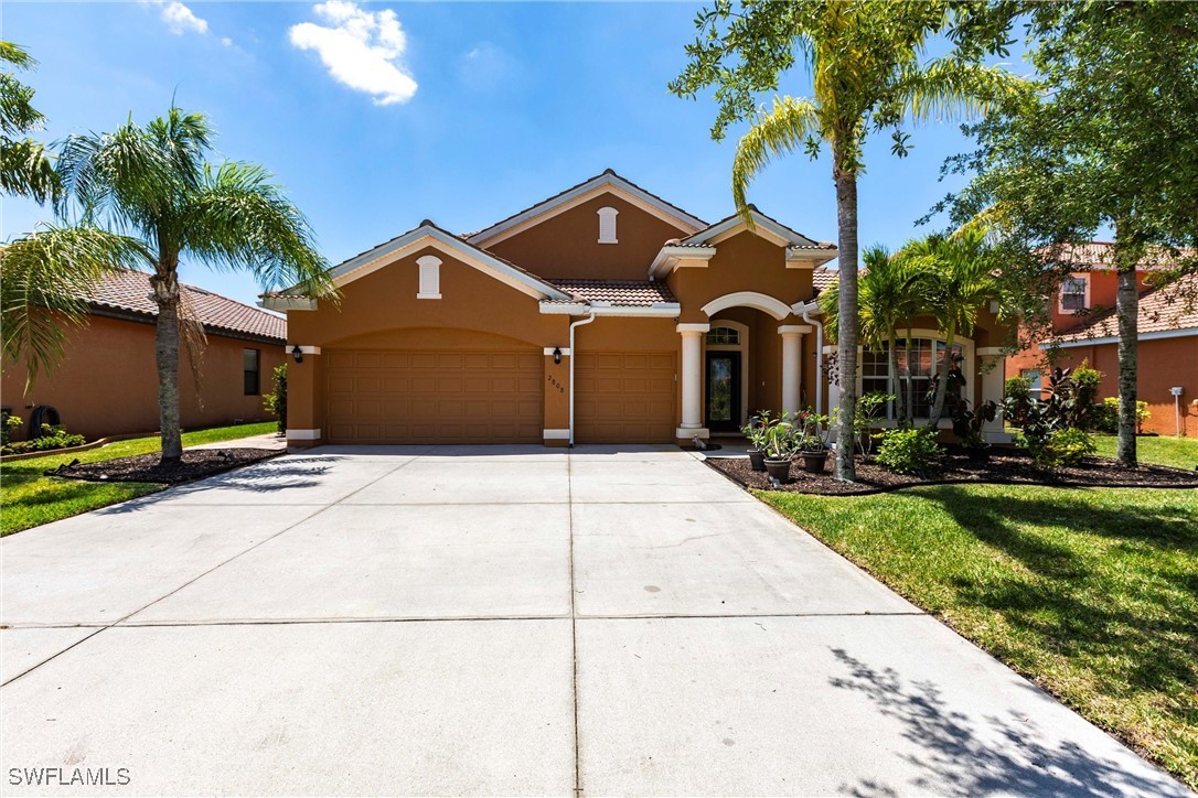 2808 Via Piazza Loop Fort Myers, FL 33905 - Photo 1 of 49 a front view of a house with a yard and garage