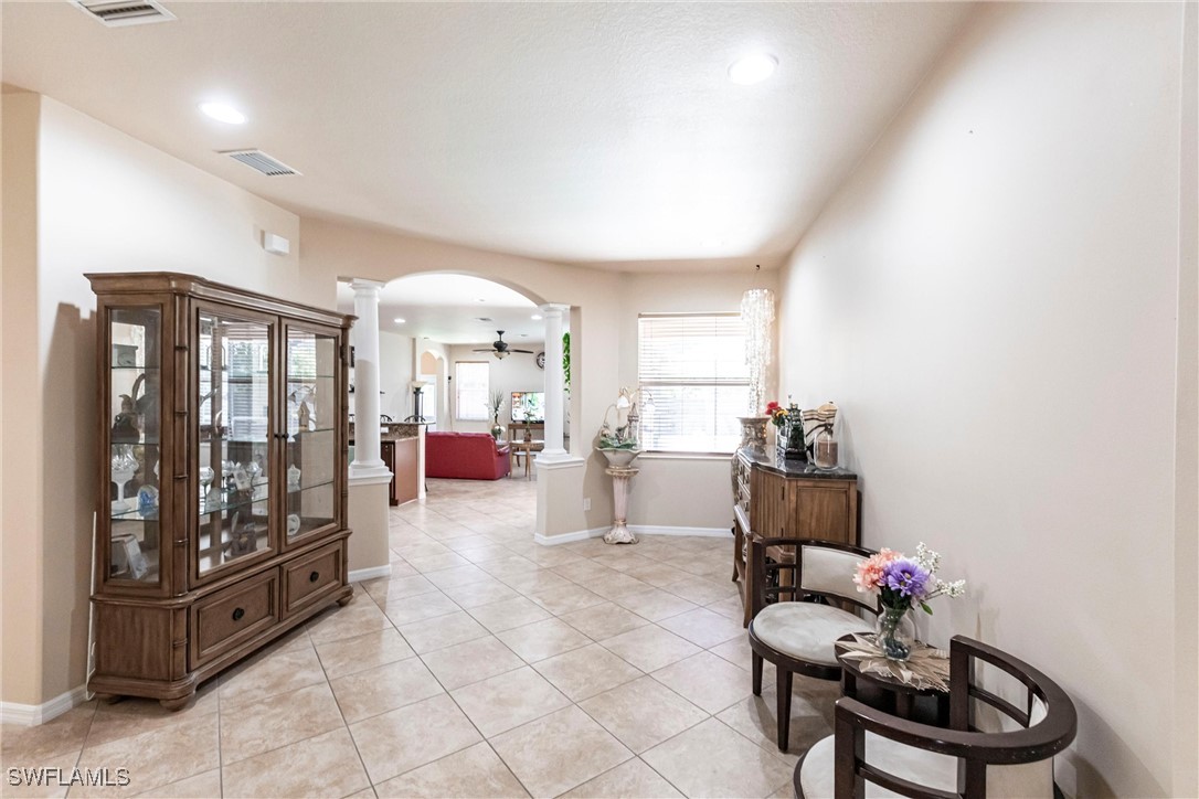 2808 Via Piazza Loop Fort Myers, FL 33905 - Photo 12 of 49 a living room with furniture and a floor to ceiling window