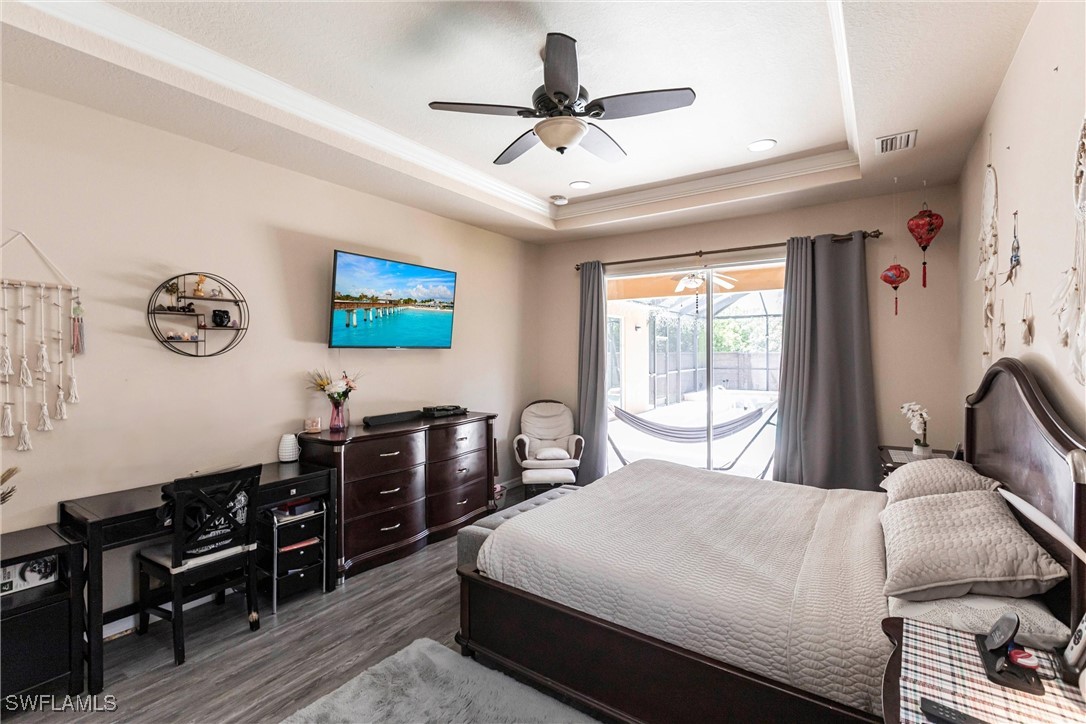2808 Via Piazza Loop Fort Myers, FL 33905 - Photo 16 of 49 a bedroom with a bed and wooden floor