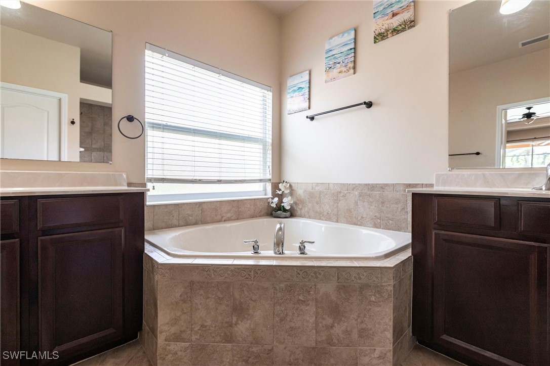 2808 Via Piazza Loop Fort Myers, FL 33905 - Photo 18 of 49 a bath tub sitting in a bathroom next to a window