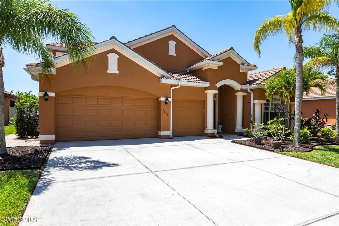 2808 Via Piazza Loop Fort Myers, FL 33905 - Photo 2 of 49 a front view of a house with garden
