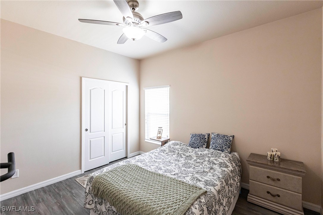 2808 Via Piazza Loop Fort Myers, FL 33905 - Photo 26 of 49 a bedroom with a bed and a chandelier